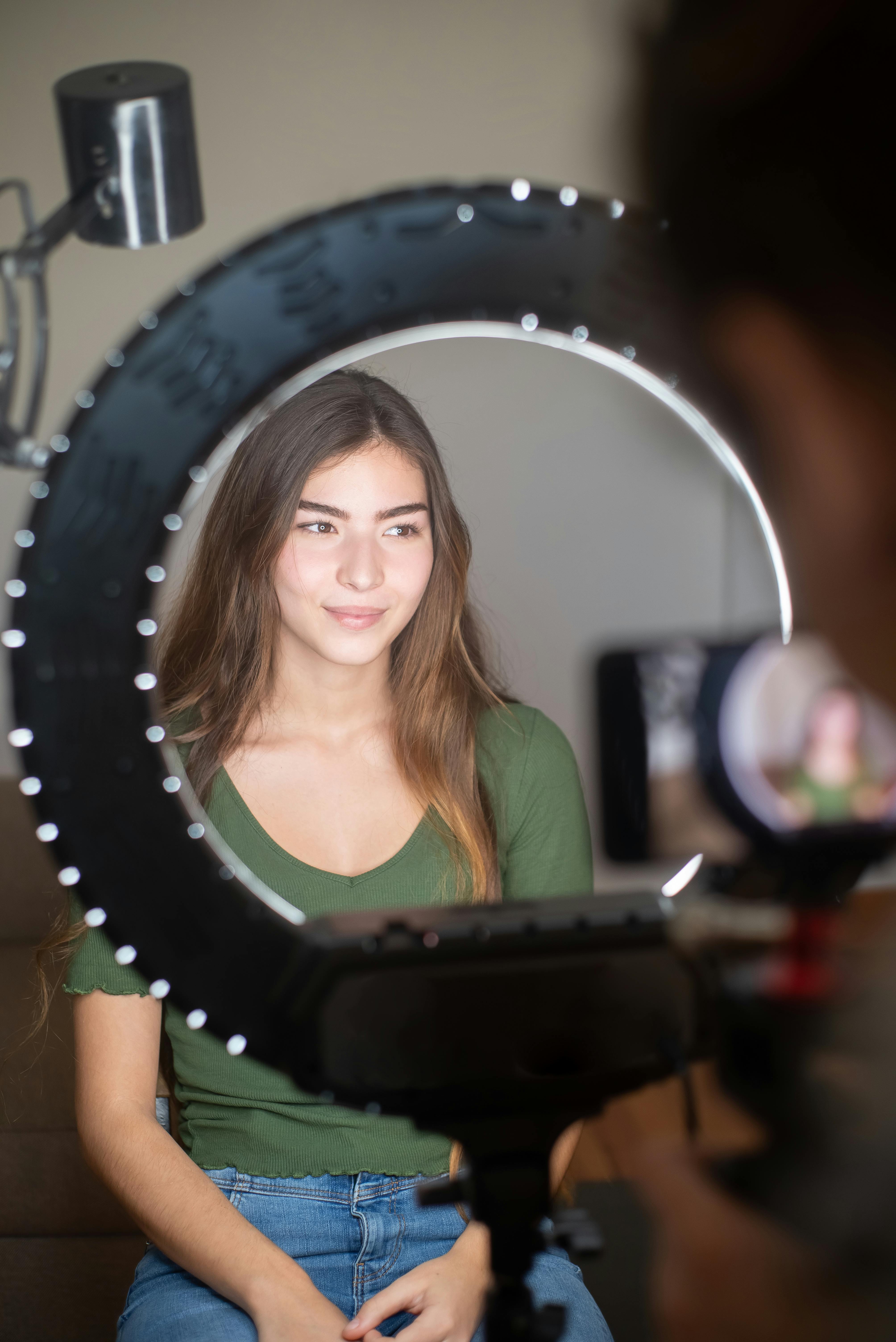 Woman standing in front of a ring light